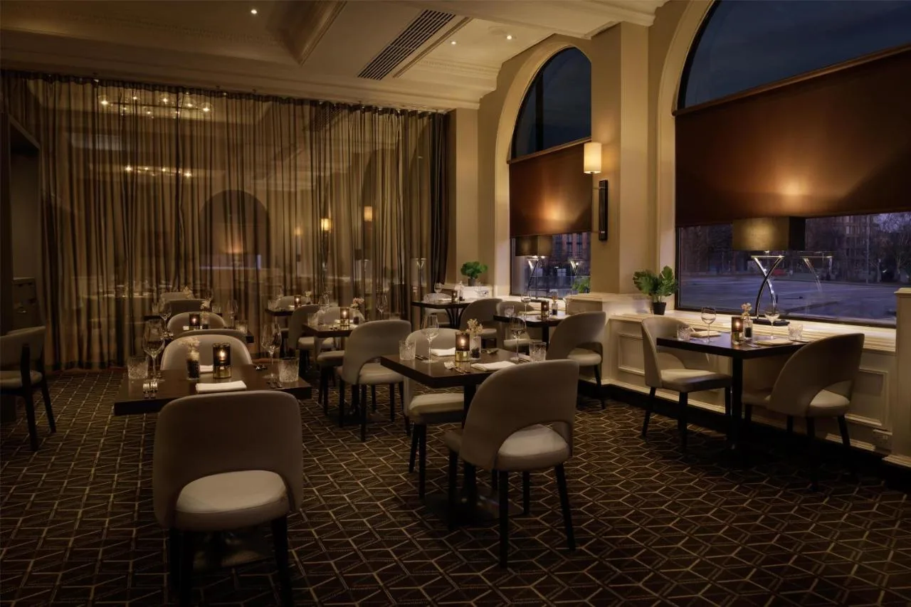 a restaurant with tables and chairs in a room at Hilton York in York