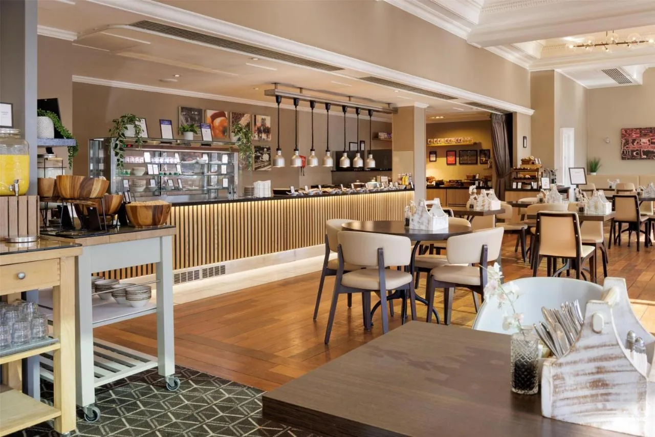 a restaurant with tables and chairs and a bar at Hilton York in York