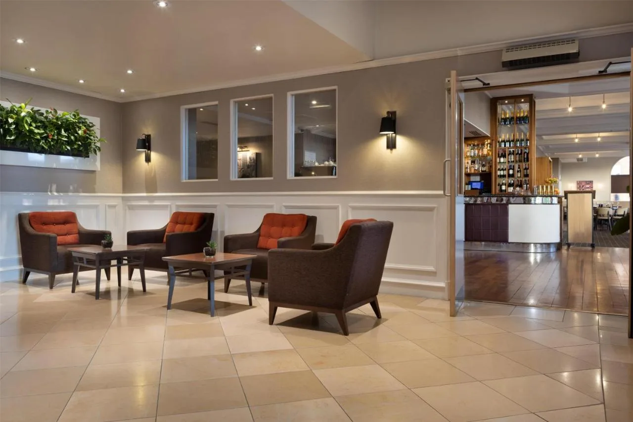 a lobby of a hotel with chairs and a table at Hilton York in York